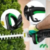 A close-up shot of a person using an electric hedge trimmer on a green bush. The image highlights the handle and blade of the trimmer. Náhľad obrázku produktu