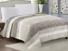 A bed with a striped quilt and white pillows. Náhled obrázku produktu