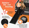 A dog ramp is shown extending from the back of a car, with a dog sitting at the top of the ramp. Produktbild-Vorschau