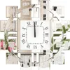 A decorative wall clock with Roman numerals and mirrored elements. Anteprima dell’immagine prodotto