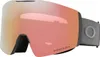 A pair of Oakley ski goggles with a rose gold mirrored lens and a gray strap, shown against a white background. Náhled obrázku produktu