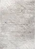 A close-up view of a rug with a distressed, abstract pattern. Anteprima dell’immagine prodotto