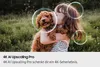 A child holding a puppy in a grassy outdoor setting. Voir les images du produit