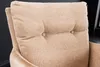 A close-up view of a tufted cushion on a chair. Produktbild-Vorschau