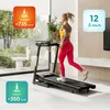 A woman is running on a treadmill in a modern living room with large windows. Produktbild-Vorschau
