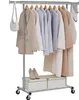 A clothing rack with various garments and accessories displayed on it, along with storage boxes and shoes at the bottom. Produktbild-Vorschau