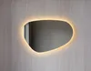A modern, irregularly shaped mirror with integrated LED lighting mounted on a textured gray wall. Anteprima dell’immagine prodotto