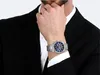 A man wearing a suit and a watch. Produktbild-Vorschau