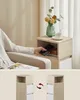 A person is placing a phone into an open shelf of a nightstand. The lower part of the image shows two views of a nightstand, highlighting its drawers and open compartment. Náhled obrázku produktu