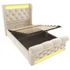 A beige upholstered bed frame with the mattress support raised, revealing storage space underneath. The bed has a tufted headboard and footboard with integrated LED lighting. Náhled obrázku produktu