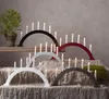 Multiple arched candle holders with electric candles are displayed on a table covered with a textured cloth. Produktbild-Vorschau