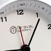 A close-up view of a white analog clock face with black and red hands, showing the numbers 11, 12, 1, and 2. The brand name 'Miraval Germany' is visible. Produktbild-Vorschau
