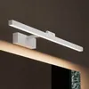 A white LED bathroom light fixture mounted on a dark brown wall above a mirror. Produktbild-Vorschau