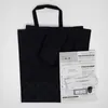 A black fabric tote bag with decorative stitching and a sewing kit laid out on top of it. Voir les images du produit