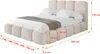 A beige upholstered bed with a headboard and side panels, shown with dimensions indicated by arrows and text. Produktbild-Vorschau