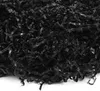 A close-up view of shredded black paper filler material. Produktbild-Vorschau