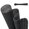 A rolled-up black PVC privacy screen and a bundle of black zip ties on a white background. Podgląd zdjęcia produktu