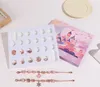 A flat lay of a DIY bracelet making kit with beads, charms, and bracelets, along with a decorative castle-themed box. Produktbild-Vorschau