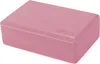 A pink yoga block is shown from a slightly elevated angle against a white background. Náhled obrázku produktu