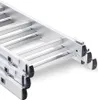 Close-up view of the bottom section of an aluminum ladder, showing the steps and rubber feet. Podgląd zdjęcia produktu