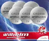 A group of button cell batteries against a background of blue lightning. Produktbild-Vorschau
