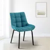 A teal upholstered dining chair with black metal legs is shown in a well-lit room with a window and a framed picture on the wall. Anteprima dell’immagine prodotto