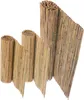 Three rolled-up bamboo mats of varying sizes are displayed against a white background.