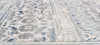 A close-up, angled view of a rug with a distressed pattern in shades of gray, blue, and white. Anteprima dell’immagine prodotto