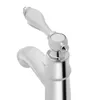 A close-up, studio shot of a silver faucet with a white handle against a white background. Podgląd zdjęcia produktu