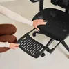 A person's hands are shown adjusting a footrest attached to an office chair. Produktbild-Vorschau