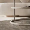 A close-up view of a modern coffee table with a magazine on its surface, set against a soft, neutral background. Produktbild-Vorschau