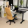 A woman is working at a standing desk in a home office setting. Náhľad obrázku produktu