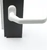 A close-up shot of a white door handle on a black door frame. Produktbild-Vorschau