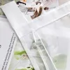 A close-up of a white sheer curtain with a drawstring and a plastic clip, layered over a background image of green apples and text. Produktbild-Vorschau