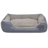 A gray dog bed with a plush interior and a paw print logo on the side, presented on a white background. Produktbild-Vorschau