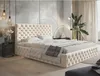 A bedroom scene featuring a tufted beige bed.