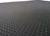 A close-up, angled view of a textured black surface with a pattern of small, raised dots. Produktbild-Vorschau
