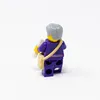 A LEGO minifigure from behind, holding a letter and wearing a satchel. Produktbild-Vorschau