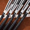 Several tennis rackets are lined up on a clay tennis court. Produktbild-Vorschau