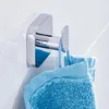 A chrome towel hook mounted on a tiled wall, with a blue towel hanging from it. Anteprima dell’immagine prodotto