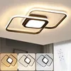 A modern ceiling light fixture with interlocking square frames, shown against a ceiling and a wall with vertical stripes. Below the main image, there are three smaller inset images showing the light fixture in different color temperatures. Produktbild-Vorschau