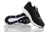 A pair of black and white Under Armour running shoes are shown against a white background. One shoe is upright and the other is lying on its side, showing the sole. Produktbild-Vorschau