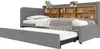 A gray upholstered daybed with a pull-out trundle bed and a wooden shelf unit built into the headboard. Anteprima dell’immagine prodotto