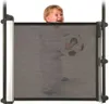 A child is peeking over a baby gate while holding a soccer ball. Náhľad obrázku produktu