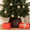 A Christmas tree decorated with ornaments and gifts underneath, with a tree skirt. Produktbild-Vorschau
