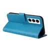 A blue flip phone case with a floral and butterfly pattern is shown open, revealing the inside of the case and the camera cutout of a phone. Produktbild-Vorschau