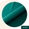 A close-up, rolled shot of teal velvet fabric, showcasing its texture and sheen, within a circular frame. Anteprima dell’immagine prodotto