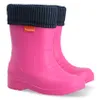 A pair of pink rain boots with navy blue cuffs.