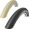 Two bicycle tires, one cream and one black, are shown against a white background. Náhľad obrázku produktu
