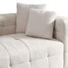 A close-up view of a beige bouclé sofa with two throw pillows. Voir les images du produit